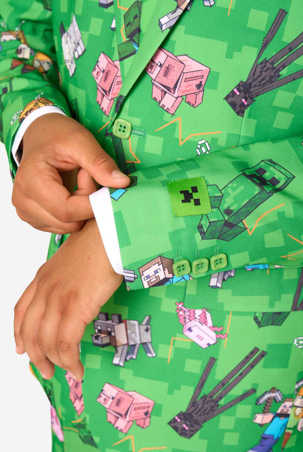 A teen boy wearing a bright green Minecraft suit with iconic characters, including Creepers and Steve - Close up of the sleeves