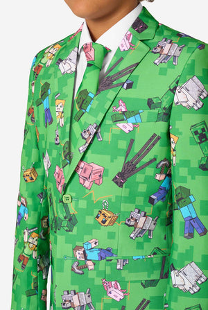 A teen boy wearing a bright green Minecraft suit with iconic characters, including Creepers and Steve - Close up of the chest
