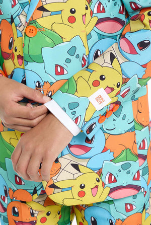 Teen wearing formal multi color suit with all-over Pokemon print. The suit contains the characters Pikachu, Bulbasaur, Charmander and Squirtle. Sleeve close up.