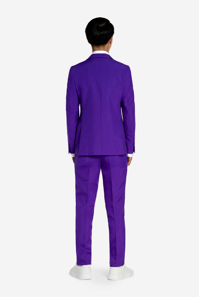 Teen wearing purple teen boys suit, view from the back