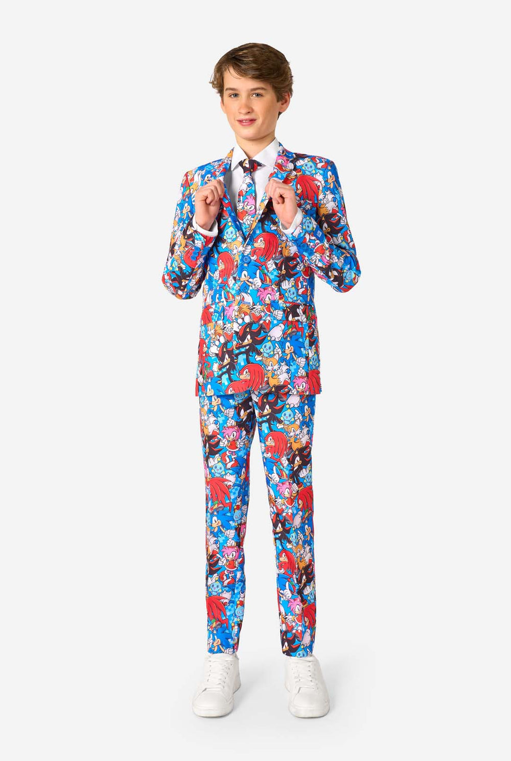 Teen boy wearing a vibrant Sonic teen suit featuring colorful prints of Sonic the Hedgehog characters including Sonic, Knuckles, Tails, and Amy, paired with a matching tie and white shirt.