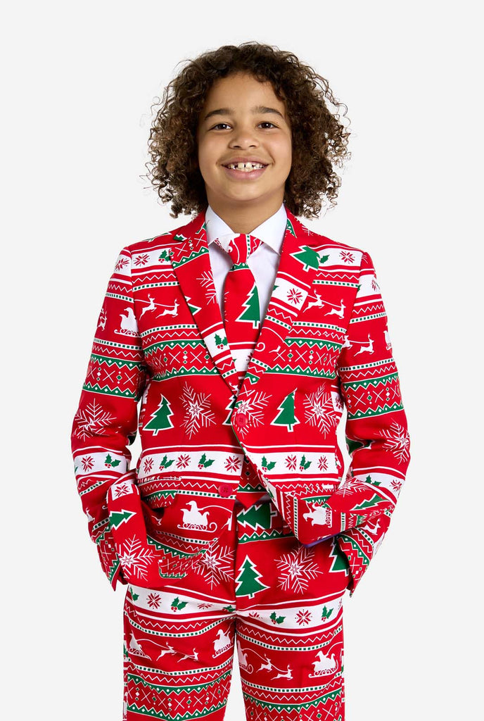 Teen wearing red Christmas suit with green and white Christmas icons, like Christmas tree, snowflakes, holly and sled with reindeers.