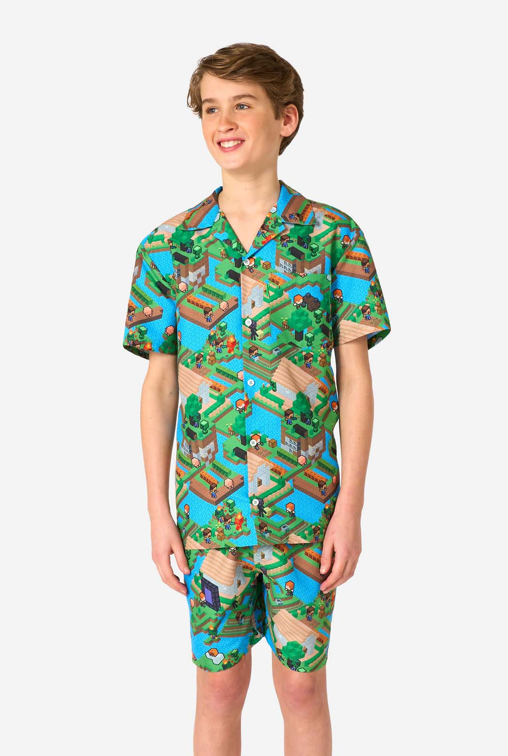 A Teen boy wearing a colorful summer outfit featuring a Minecraft Overworld print, showcasing pixelated landscapes, characters, and elements from the iconic game. The short-sleeve shirt and matching shorts highlight a vibrant design inspired by the Minecraft universe. 