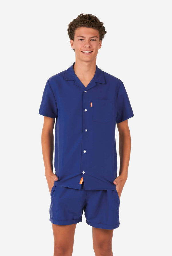  Teen wearing dark blue summer set, consisting of shorts and shirt