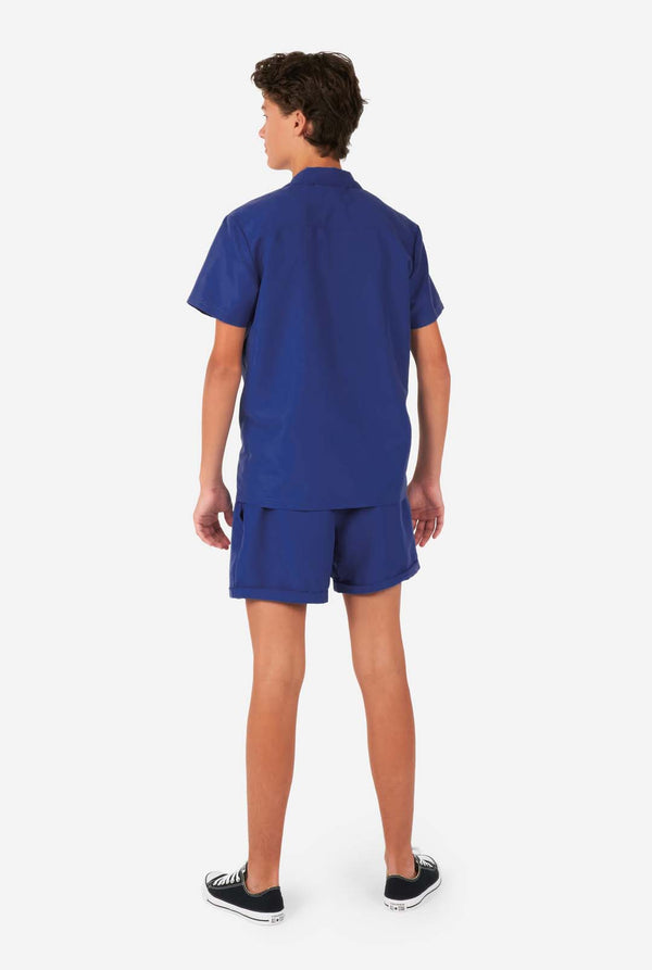 Boy wearing dark blue summer set, consisting of shorts and shirt, view from the back