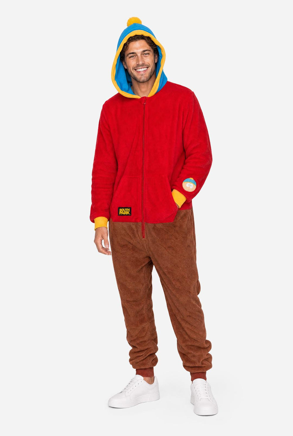 Male model wearing a red and brown South Park Cartman adult onesie with blue and yellow hood.