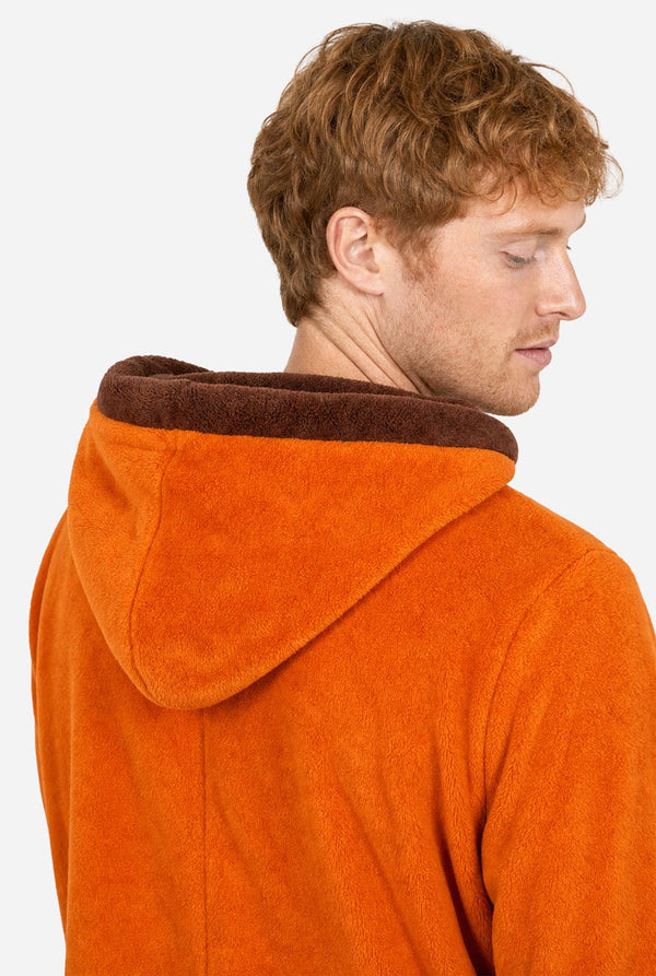 Close-up back view of the Kenny onesie showing the orange hood with contrasting brown lining.