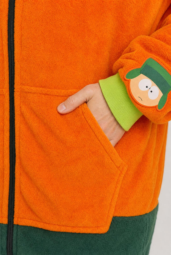 Close-up of the Kyle onesie showing the front pocket, green cuff and character sleeve patch.
