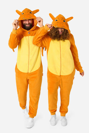 Two men modeling matching orange and yellow plush kigurumi hooded onesies with dragon-like hood details, standing against a light gray studio background.