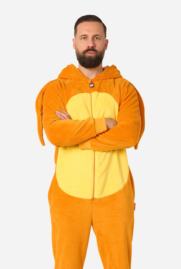 A man wearing a plush animal onesie in orange and yellow, standing with arms crossed against a light gray background.