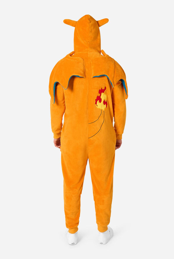 A person wearing a plush orange hooded one-piece costume viewed from the back, with small animal-like ears on the hood, blue trim details, and a red-and-yellow flame graphic on the back, against a light gray studio background.