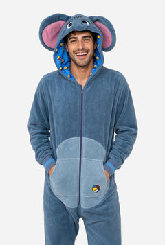 A man wearing a blue elephant onesie pajama with pink inner ears, a full front zipper, and a hood, standing against a light gray background.