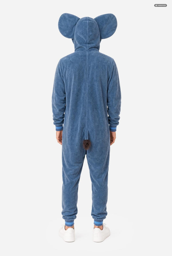 A person viewed from the back wearing a blue plush animal onesie with large ears on the hood and a small tail at the back, paired with white sneakers, against a light gray studio background.