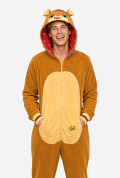 A man wearing a plush lion onesie pajama with a hood featuring a lion face and ears, a tan belly patch, and a red patterned hood lining, against a light gray background.