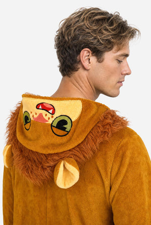 A man wearing a plush lion onesie pajama with a hood featuring a lion face and ears, a tan belly patch, and a red patterned hood lining, against a white background. Close up of the hood.