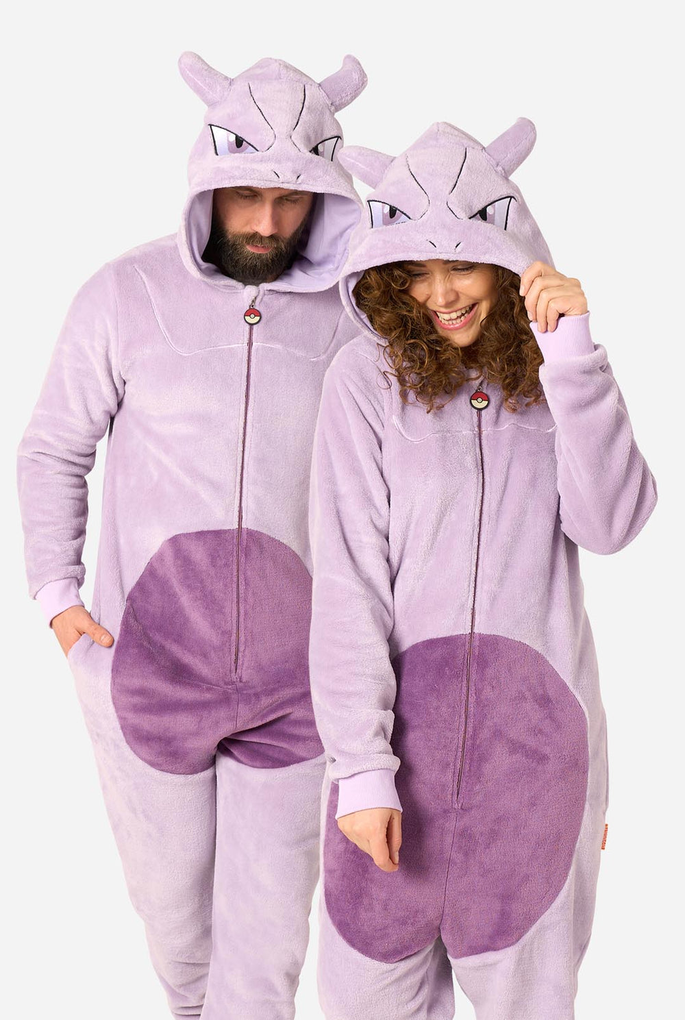 Two models wearing matching light purple and purple plush onesie pajamas with Mewtwo hood details, shown against a plain light gray background.