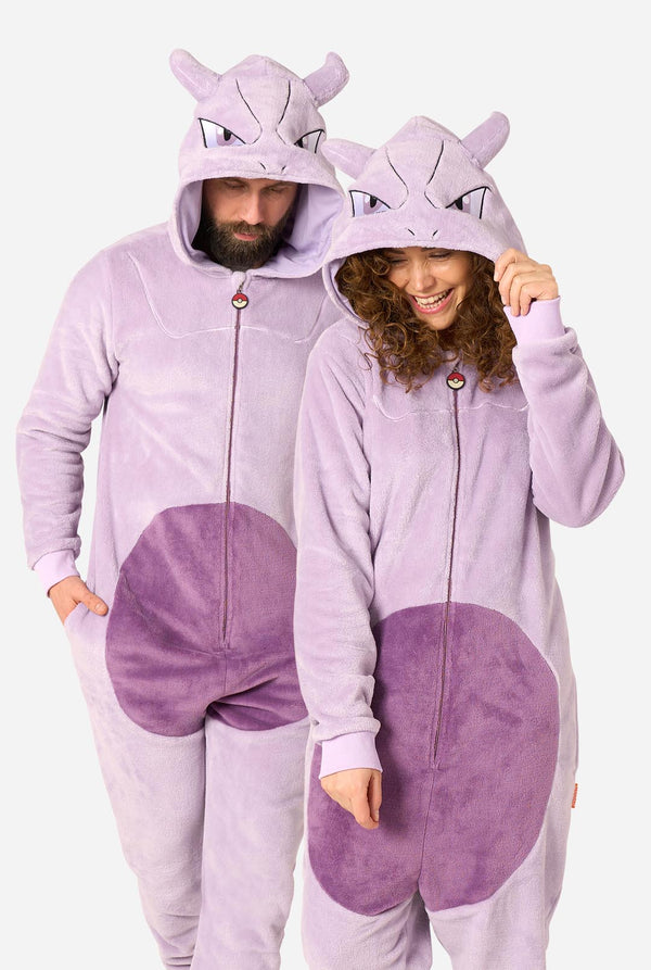 Two models wearing matching light purple and purple plush onesie pajamas with Mewtwo hood details, shown against a plain light gray background.