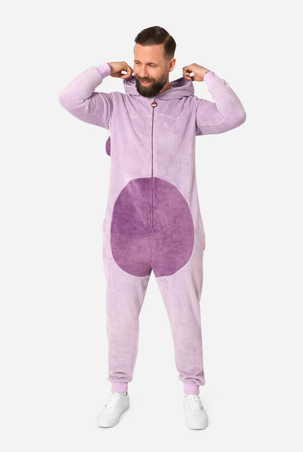 A man modeling a light purple full-zip hooded onesie with a darker purple circular patch on the front, posed against a solid light gray background.