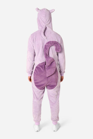 A person wearing a plush Mewtwo onesie, shown from the back. The one-piece features a light lavender body with a darker purple patch on the back and small ears on the hood, set against a plain light gray background.