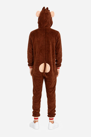 A man wearing a brown plush animal onesie with a hood shaped like a monkey face, featuring pink ears, a yellow inner hood lining, and a large tan belly patch on the front, photographed against a white studio background. View from the back.