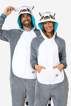 Two people wearing matching lemur-themed onesies on a white background