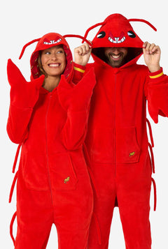Two people wearing red lobster-themed onesies against a white background