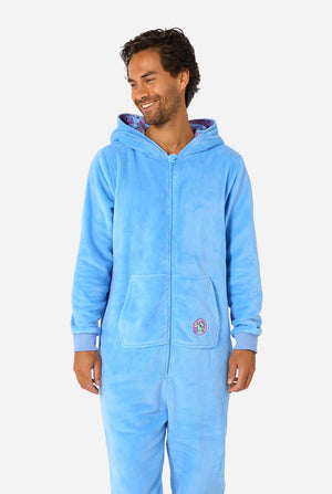 Man wearing a blue My Little Pony onesie with a hood on a light background. Hood down.