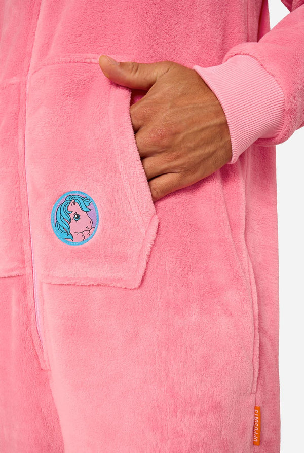 Man wearing a pink onesie with a My Little Pony design on a light background. Sleeve close up.
