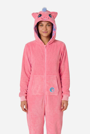 Woman wearing a pink onesie with a My Little Pony design on a light background. Hood up.