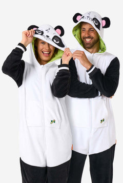 Two people wearing panda-themed onesies with a white background