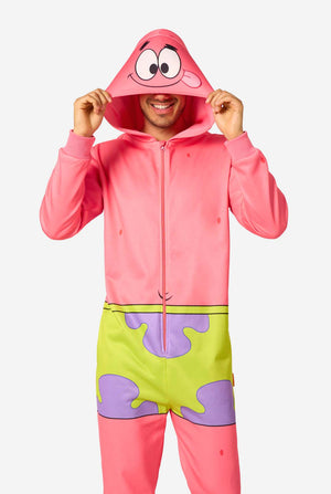 Adult wearing a pink Patrick Star onesie with a front zipper, green shorts design, and a hood featuring Patrick’s face, holding the hood edges.