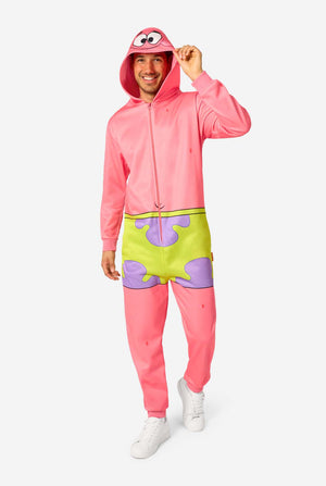 Full-body view of an adult wearing a pink Patrick Star onesie with a hood featuring Patrick’s face, green shorts design, and white sneakers