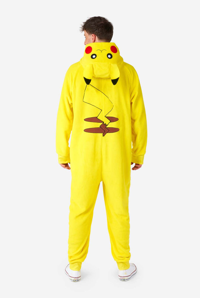 A man is wearing a vibrant Pikachu onesie, designed to resemble the iconic Pokémon character. This unisex adult onesie is bright yellow with Pikachu’s recognizable face on the hood, featuring large black-tipped ears, black eyes, red cheeks, and a cute smile. The onesie has a convenient front zipper closure and two front pockets for functionality and comfort. The soft, cozy material makes it perfect for lounging, cosplay events, or Pokémon-themed gatherings. Ideal for Pokémon fans. View from the back.