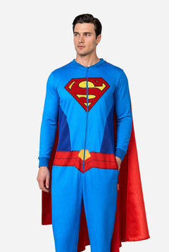 Man wearing a Superman onesie with a red cape on a white background