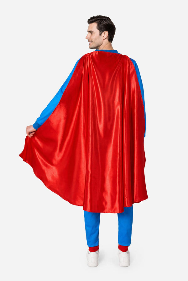 Image of a man wearing a blue and red Superman onesie with a red cape on a light background. View from the back.