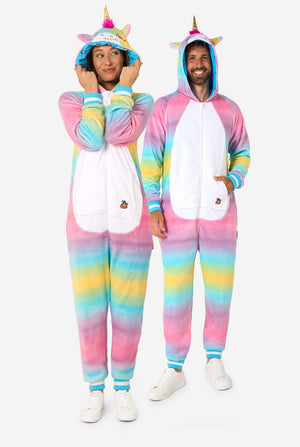 A man and women are wearing a colorful adult onesie designed as a rainbow unicorn. The onesie features a vibrant gradient of pastel colors, a golden horn, and playful unicorn details, perfect for cozy lounging or costume parties. The men and women both have their hood on. Full body image.