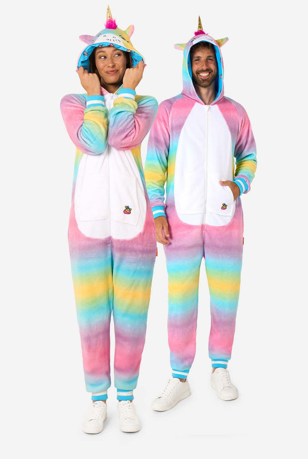 A man and women are wearing a colorful adult onesie designed as a rainbow unicorn. The onesie features a vibrant gradient of pastel colors, a golden horn, and playful unicorn details, perfect for cozy lounging or costume parties. The men and women both have their hood on. Full body image.