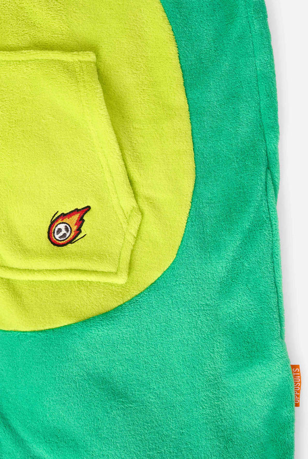 A kid is wearing a green dinosaur kids onesie featuring playful hood details and cozy, soft material, perfect for lounging or costume events. Focused on the pockets.