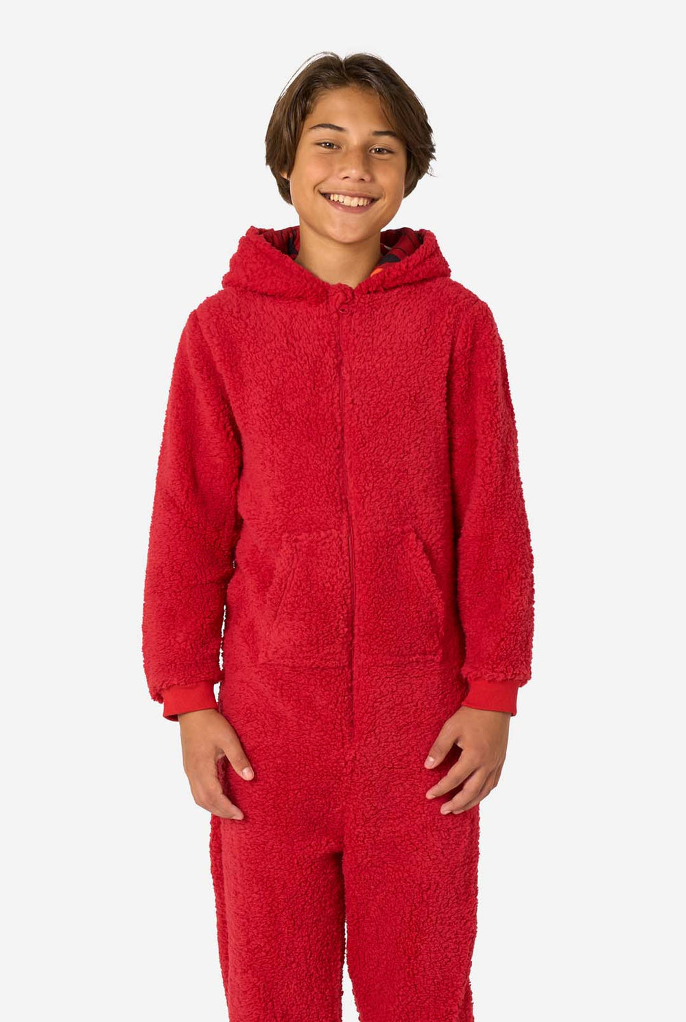 Kid is wearing a red onesie resembling Elmo. He has his right hand in his pocket.