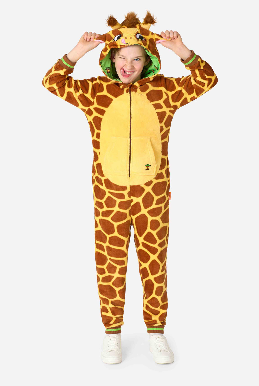 A smiling kid is wearing a brown and yellow kids onesie designed as a giraffe. The onesie features a hood resembling a Giraffes head.