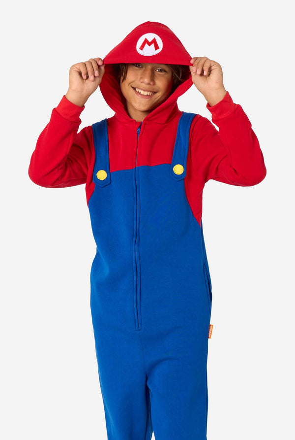 A child wearing a red and blue Mario onesie with a hood, resembling the famous video game character.