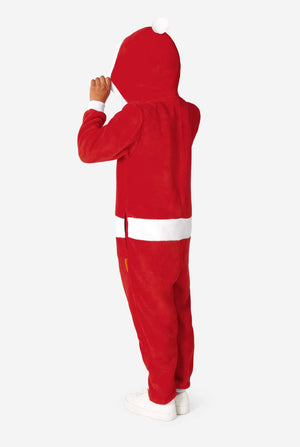 Child turned slightly to the side, lifting the hood of a red Santa onesie, showing the white pom-pom on the back.