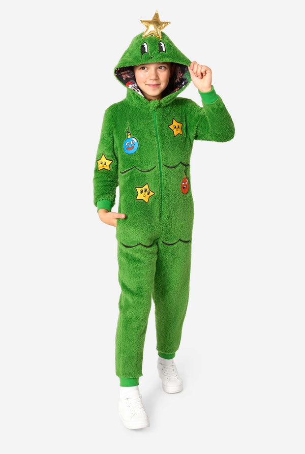 Full-body view of a child walking forward in a green Christmas tree onesie with hood, gold star detail, and white sneakers.