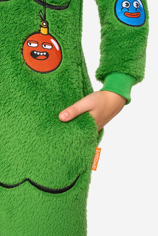 Close-up of the green plush Christmas tree onesie showing an ornament patch, front pocket, and orange OppoSuits label.