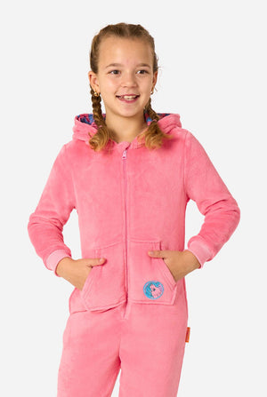 Child wearing a pink onesie resembling a My Little Pony on a light background. Hood down.
