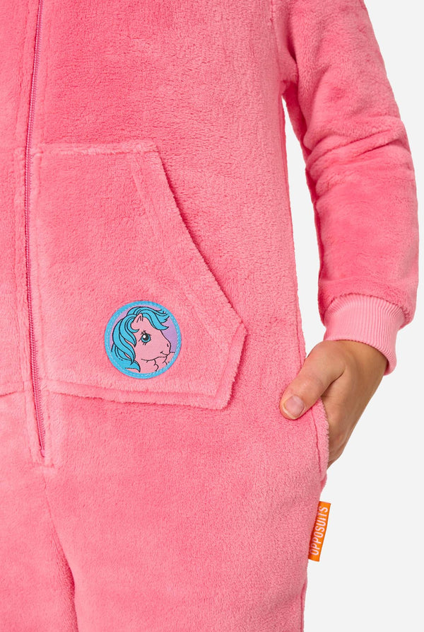 Child wearing a pink onesie resembling a My Little Pony on a light background. Pocket close up.