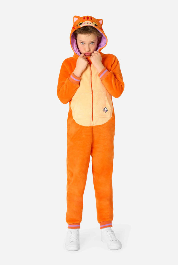 Child wearing a playful unisex kids onesie designed as a red-orange cat, featuring a hood with a cartoon cat face, ears, and a light beige belly panel, making a silly face against a plain background.