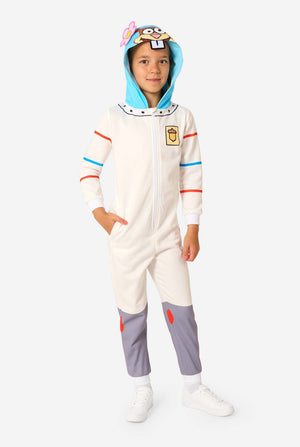 Child wearing a white Sandy Cheeks onesie with a blue hood featuring Sandy’s cartoon face and flower, hands in pockets, and grey leg panels