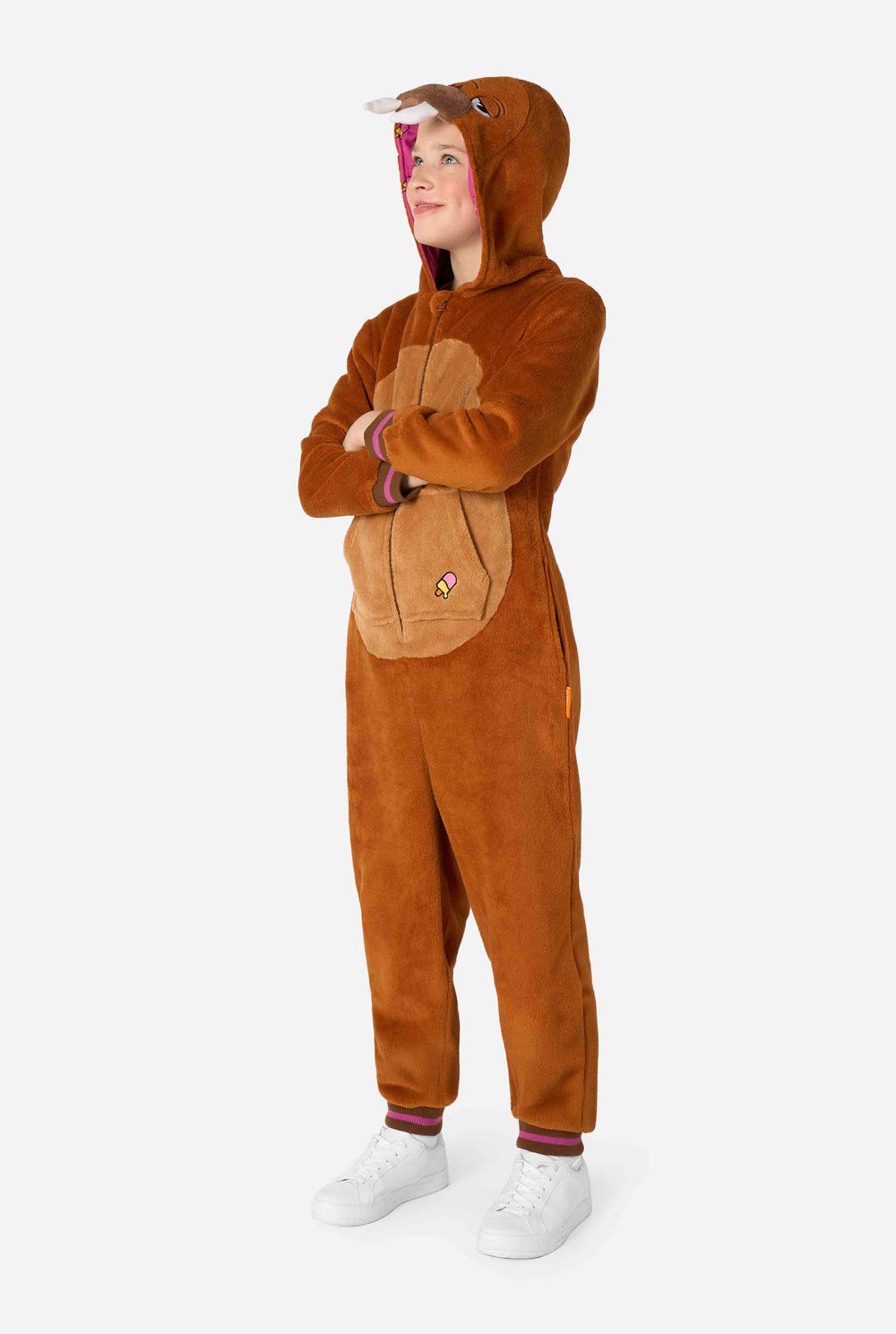 A cheerful kid wearing a brown kids onesie designed as a walrus. The onesie features a hood with fangs, stitched gloves resembling paws, and playful walrus details, perfect for cozy lounging or costume parties.