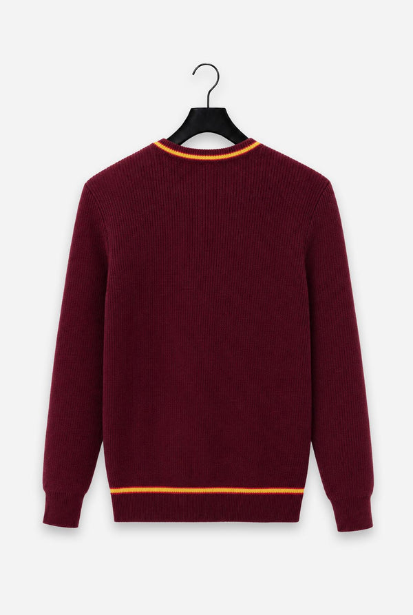 A maroon ribbed knit Harry Potter Gryffindor sweater with orange contrast trim at the crew neck and hem, hanging on a black hanger against a light gray background.